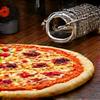 Pizza stone with a gourmet pizza and various grilling baskets